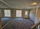 The spacious living room is illuminated with natural light from the two large windows at 400 Prince Of Wales, Stone Mountain, GA 30083