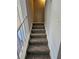 Carpeted staircase with white railing, providing access to the upper level at 400 Prince Of Wales, Stone Mountain, GA 30083