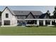Backyard of a pristine white home with a swimming pool, covered patio, and an expansive green lawn at 1580 Mayfield Rd, Alpharetta, GA 30009