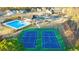 Aerial view of community amenities: pool, tennis courts, and playground nestled among beautiful homes at 1818 Lacebark Elm Way, Lawrenceville, GA 30045