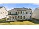 Rear view of home shows large backyard, covered patio, and plenty of windows for natural light at 1818 Lacebark Elm Way, Lawrenceville, GA 30045