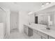 Modern bathroom with double vanity, framed mirrors, and a glass-enclosed shower at 1818 Lacebark Elm Way, Lawrenceville, GA 30045