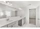 Bright bathroom with double sinks, a large mirror, and an enclosed glass shower at 1818 Lacebark Elm Way, Lawrenceville, GA 30045