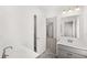 Bright bathroom featuring double sinks, modern fixtures, and a separate lavatory for convenience at 1818 Lacebark Elm Way, Lawrenceville, GA 30045