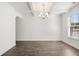 Spacious dining room with coffered ceilings, a chandelier, and hardwood floors for elegant dining at 1818 Lacebark Elm Way, Lawrenceville, GA 30045