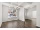 Bright dining room with coffered ceilings, chandelier, hardwood floors, and large window with neighborhood views at 1818 Lacebark Elm Way, Lawrenceville, GA 30045
