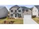 Two-story home with brick and siding exterior, well-maintained lawn, and attached two-car garage at 1818 Lacebark Elm Way, Lawrenceville, GA 30045