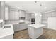 Stylish kitchen featuring stainless steel appliances, central island and pendant lighting at 1818 Lacebark Elm Way, Lawrenceville, GA 30045