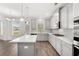 Open concept kitchen with stainless steel appliances, island, and modern finishes at 1818 Lacebark Elm Way, Lawrenceville, GA 30045