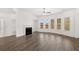 Bright living room with hardwood floors, fireplace, and multiple large windows at 1818 Lacebark Elm Way, Lawrenceville, GA 30045