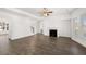 Open-concept living room with fireplace and hardwood flooring at 1818 Lacebark Elm Way, Lawrenceville, GA 30045