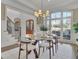 Dining room featuring large windows with a view of the front yard and glass-topped dining table at 3224 Lanier Ne Dr, Atlanta, GA 30319