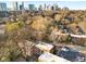 Overhead view of the complex surrounded by mature trees with a city skyline at 323 3Rd Ne St # 5, Atlanta, GA 30308