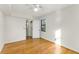 Bright bedroom featuring hardwood floors, white walls, and natural light from the window at 323 3Rd Ne St # 5, Atlanta, GA 30308