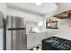 Updated kitchen with checkerboard floors, white cabinets, and stainless steel refrigerator at 323 3Rd Ne St # 5, Atlanta, GA 30308