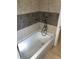Relaxing bathroom featuring an alcove tub with a shower and decorative tile surround at 1625 Linda Dr, Decatur, GA 30032