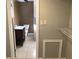 Bathroom entrance with neutral tile and updated vanity leading to the toilet and shower area at 1625 Linda Dr, Decatur, GA 30032
