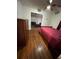 Bedroom with hardwood floors featuring a dresser and a single bed that opens to a secondary space at 1625 Linda Dr, Decatur, GA 30032