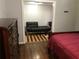 Bedroom with hardwood floors featuring a dresser and a single bed that opens to a secondary space at 1625 Linda Dr, Decatur, GA 30032