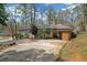 Exterior view of the home featuring a driveway, small yard, and carport at 1625 Linda Dr, Decatur, GA 30032