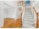 Bright foyer features hardwood floors, a staircase with white railings, and an open layout, creating a welcoming entrance at 2382 Waterscape Trl, Snellville, GA 30078