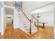 The foyer showcases hardwood floors, a staircase with white railings, and an open view to the adjacent dining area at 2382 Waterscape Trl, Snellville, GA 30078