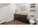 Well lit bathroom with updated vanity, dark cabinets, tile flooring and modern lighting at 1080 Peachtree Ne St # 2006, Atlanta, GA 30309