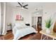 Calm and inviting bedroom featuring hardwood floors, a ceiling fan, and an ensuite bathroom at 1080 Peachtree Ne St # 2006, Atlanta, GA 30309