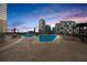 Community rooftop pool area with comfortable lounge chairs and skyline views at 1080 Peachtree Ne St # 2006, Atlanta, GA 30309