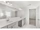 Bright bathroom featuring double sink vanity with modern fixtures and a glass enclosed shower at 1891 Lacebark Elm Way, Lawrenceville, GA 30045