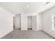 Neutral colored bedroom with carpet, window, and doors into a walk-in closet at 1891 Lacebark Elm Way, Lawrenceville, GA 30045