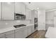 Modern kitchen includes stainless steel appliances, light countertops, and stylish gray cabinetry at 1891 Lacebark Elm Way, Lawrenceville, GA 30045