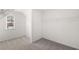 Neutral colored walk-in closet with window and wire shelving at 1891 Lacebark Elm Way, Lawrenceville, GA 30045