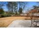 A stone patio offers a relaxing outdoor space in this expansive backyard, surrounded by lush greenery and mature trees at 3063 Peachtree Ne Dr, Atlanta, GA 30305