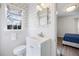 Cozy bathroom with patterned wallpaper, white vanity, and a sunlit window at 3063 Peachtree Ne Dr, Atlanta, GA 30305