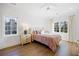 Sun-filled bedroom features hardwood floors, neutral walls, and dual windows with curtains at 3063 Peachtree Ne Dr, Atlanta, GA 30305