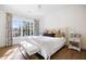 Sunlit bedroom features a large window, a queen size bed, and hardwood floors at 3063 Peachtree Ne Dr, Atlanta, GA 30305