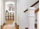 Hallway featuring hardwood floors, and views into the kitchen with counter seating and a decorative light fixture at 3063 Peachtree Ne Dr, Atlanta, GA 30305