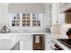 Bright kitchen showcasing a farmhouse sink, stainless steel appliances, and quartz countertops at 3063 Peachtree Ne Dr, Atlanta, GA 30305