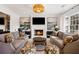 Cozy living room features fireplace, flat screen, elegant sofas, and modern decor at 3063 Peachtree Ne Dr, Atlanta, GA 30305