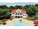 Aerial shot featuring a community pool with lounge chairs and tables, surrounded by lush greenery and trees at 412 Barley Lot 86 Ct, Covington, GA 30014