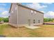 Exterior view of the house with new siding, an unfinished lawn, and a patio area at 412 Barley Lot 86 Ct, Covington, GA 30014