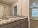 Bathroom featuring double vanity with granite countertops and large mirror at 412 Barley Lot 86 Ct, Covington, GA 30014