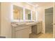 Bright bathroom with granite counters, double sinks, and modern, lit mirrors at 412 Barley Lot 86 Ct, Covington, GA 30014