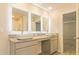 Stylish bathroom with dual sinks, granite countertop, illuminated mirrors, and modern finishes at 412 Barley Lot 86 Ct, Covington, GA 30014