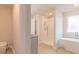 Well-lit bathroom showcasing a tiled shower, soaking tub, and modern fixtures at 412 Barley Lot 86 Ct, Covington, GA 30014