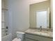 Bright bathroom with a shower, soaking tub, and stylish vanity with granite countertops at 412 Barley Lot 86 Ct, Covington, GA 30014