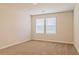 An empty bedroom featuring carpeted floors and two bright windows at 412 Barley Lot 86 Ct, Covington, GA 30014