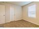 Bedroom featuring carpet, a window, and two doors at 412 Barley Lot 86 Ct, Covington, GA 30014