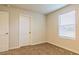 An empty bedroom features carpeted floors and a bright window at 412 Barley Lot 86 Ct, Covington, GA 30014